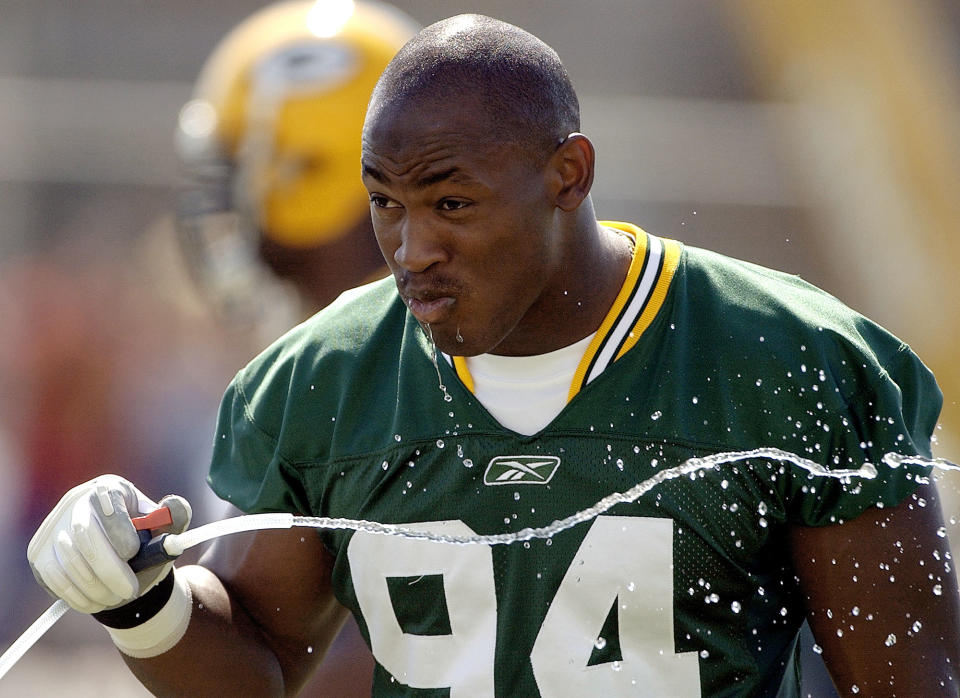 Green bay Packers defensive end Kabeer Gbaja-Biamila takes a drink of water during a break in the action at training camp Tuesday, July 29, 2003, in Green Bay, Wis. (AP Photo/Morry Gash)