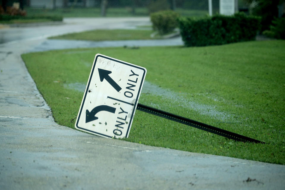 A street sign is knocked over by high winds in Coral Beach.