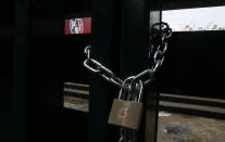 The doors of the headquarters of Mexico's Institutional Revolutionary Party, PRI, remain closed with chains in Mexico City, Wednesday, June 30, 2021. The doors are closed after party dissidents set up a ring of protesters Tuesday around the headquarters and fighting apparently broke out when a squad of loyalists tried to retake the building. (AP Photo/Marco Ugarte)