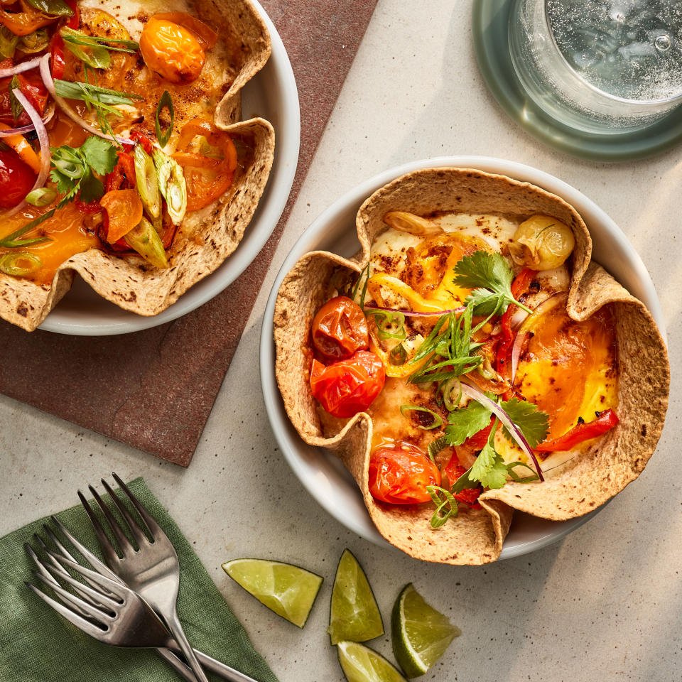 <p>These savory breakfast bowls make excellent use of the air fryer. The tortilla is the perfect vehicle for scooping up the egg, pepper and tomato filling—plus it can soak up the runny egg yolk. Lime juice adds brightness to finish the dish. <a href="https://www.eatingwell.com/recipe/8025802/air-fryer-breakfast-bowl/" rel="nofollow noopener" target="_blank" data-ylk="slk:View Recipe;elm:context_link;itc:0;sec:content-canvas" class="link ">View Recipe</a></p>