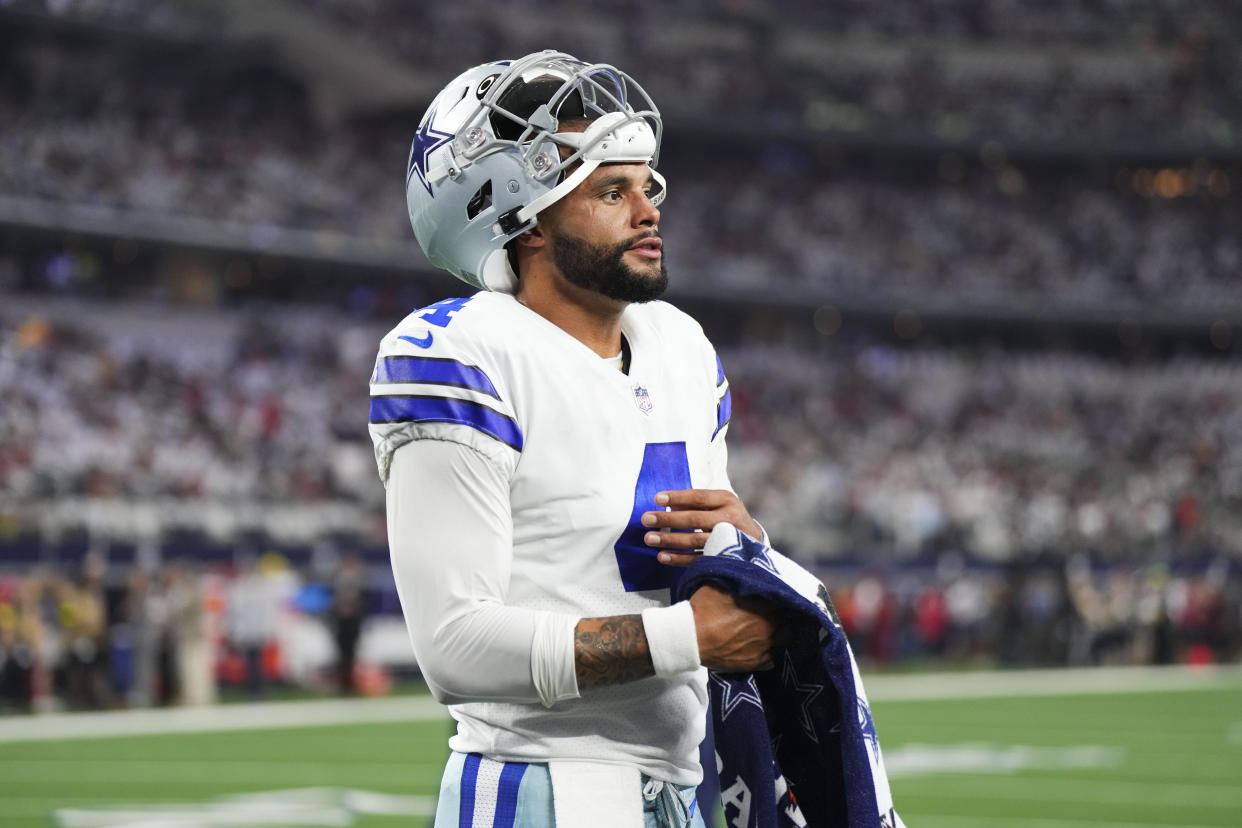 ARLINGTON, TX - SEPTEMBER 11: Dak Prescott #4 of the Dallas Cowboys uses a Gatorade towel to wipe his hand against the Tampa Bay Buccaneers at AT&T Stadium on September 11, 2022 in Arlington, TX. (Photo by Cooper Neill/Getty Images)