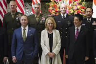 Merrill Eisenhower Atwater, the great-grandson, left bottom, Mary Jean Eisenhower, granddaughter of former U.S. President Dwight D. Eisenhower, center bottom, and Japan's Prime Minister Shinzo Abe pose for a group photo session as part of the 60th Anniversary commemorative reception of the signing of the Japan-U.S. Security Treaty at the Iikura Guesthouse in Tokyo, Sunday, Jan. 19, 2020. (AP Photo/Eugene Hoshiko, Pool)