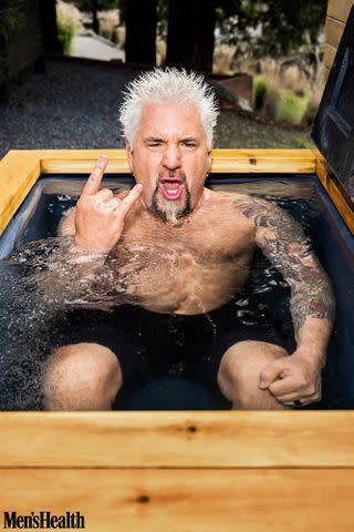 <p>Dylan Coulter for Men's Health</p> Guy Fieri in a cold plunge in 'Men's Health.'