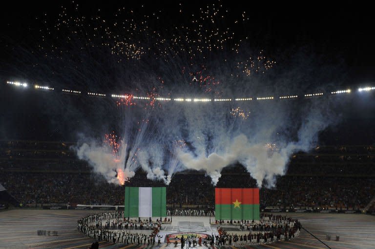 Artists perform around giant Nigerian and Burkina Faso flags during a ceremony held ahead of the kick off of the 2013 African Cup of Nations final football match between Burkina Faso and Nigeria on February 10, 2013 at Soccer City stadium in Johannesburg
