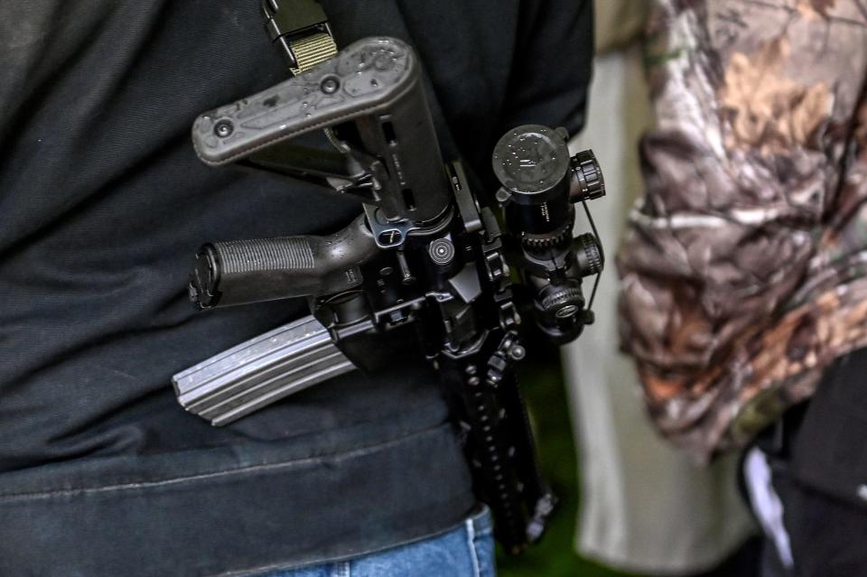 A participant open carries during the Second Amendment March on Thursday, Sept. 23, 2021, at the Capitol in Lansing, Mich.