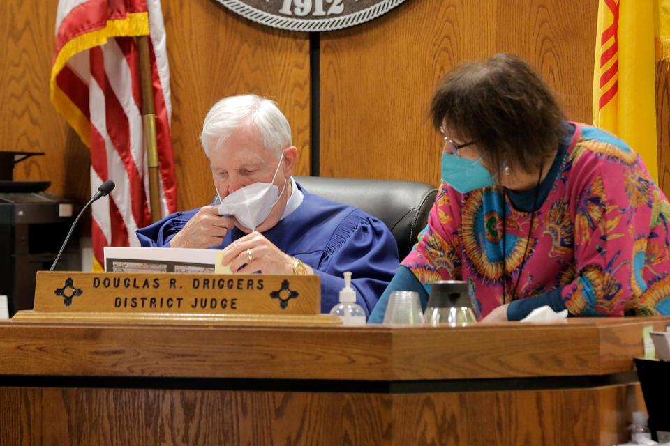 3rd Judicial District Judge Douglas Driggers, left, reviews pictures of exhibits with his assistant Jeannie Quintero on Wednesday, May 25, 2022.