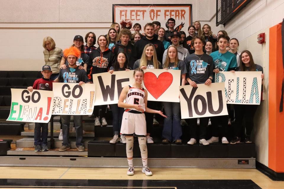 Somerset basketball player Bella Baumgardner poses for a photo in front of the Fleet of Fear on senior night, Thursday, in Somerset. Baumgardner has battled polycystic kidney disease since 2020. A special basket raffle and 50/50 drawing were held with proceeds benefitting the PKD Foundation and Baumgardner's family.