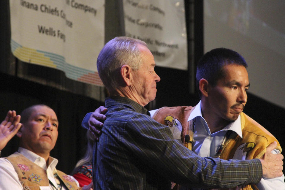 FILE -Marvin Roberts, right, hugs his lawyer, Alaska Innocence Project attorney Bill Oberly, during Roberts' address at the Alaska Federation of Natives conference in Anchorage, Alaska, on Oct. 17, 2015. Roberts and three other men were convicted of killing a Fairbanks, Alaska teenager in 1997, but prosecutors vacated the convictions in 2015 after a key witness recanted testimony and a weeks-long federal review that included new evidence and testimony. The city of Fairbanks said Monday, Nov. 6, 2023, that it had settled with three of the four men for nearly $5 million. Roberts declined a settlement offer and his case is still pending.(AP Photo/Mark Thiessen, file)