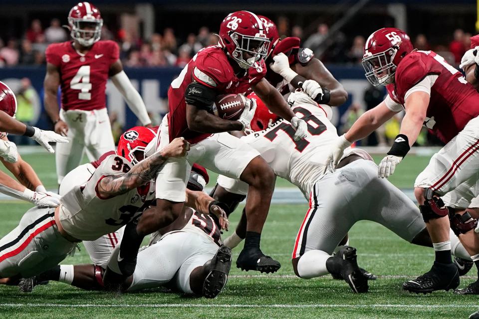 Alabama running back Jam Miller (26) rushes the ball against Georgia during the 2023 SEC championship game at Mercedes-Benz Stadium.