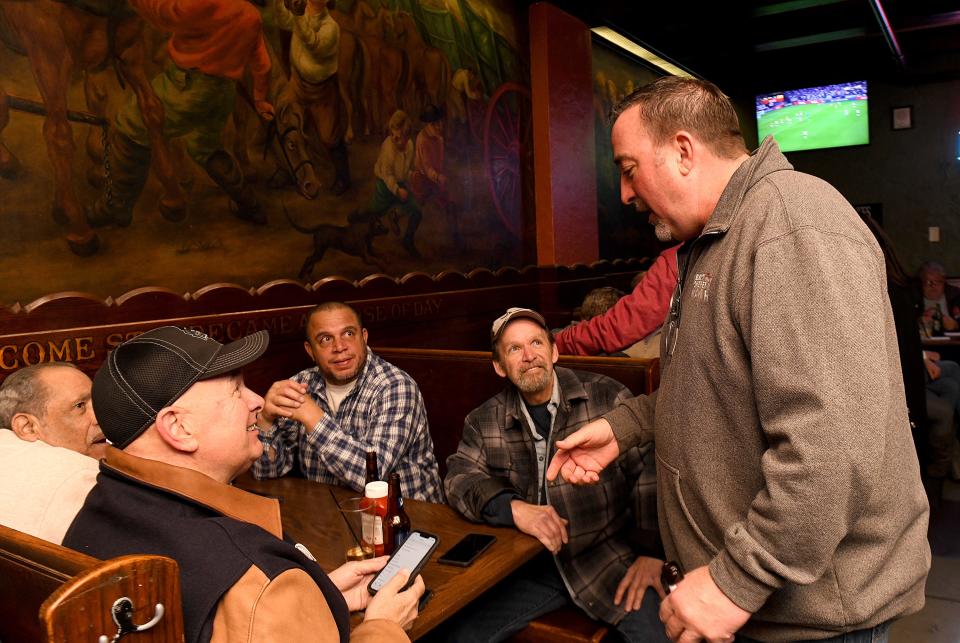 William V. Sherer II visits with supporters Tuesday as he waits for Democratic primary results for Canton mayor at Conestoga Grill.