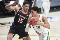 Baylor's MaCio Teague (31) drive the ball against Texas Tech's Kevin McCuller (15) during the first half of an NCAA college basketball game in Lubbock, Texas, Saturday, Jan. 16, 2021. (AP Photo/Justin Rex)