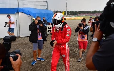 Ferrari's German driver Sebastian Vettel walks to the pits after he was forced to abandon during the German Formula One Grand Prix at the Hockenheim racing circuit on July 22, 2018 in Hockenheim, southern Germany - Credit: afp