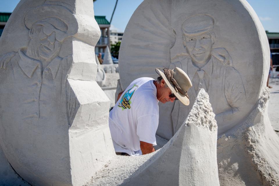 John Gowdy works on his sand sculpture titled "Soul Reunion" during the 33rd annual American Sand Sculpting Championship at Wyndham Garden Hotel in Fort Myers Beach on Sunday, November 24, 2019. 