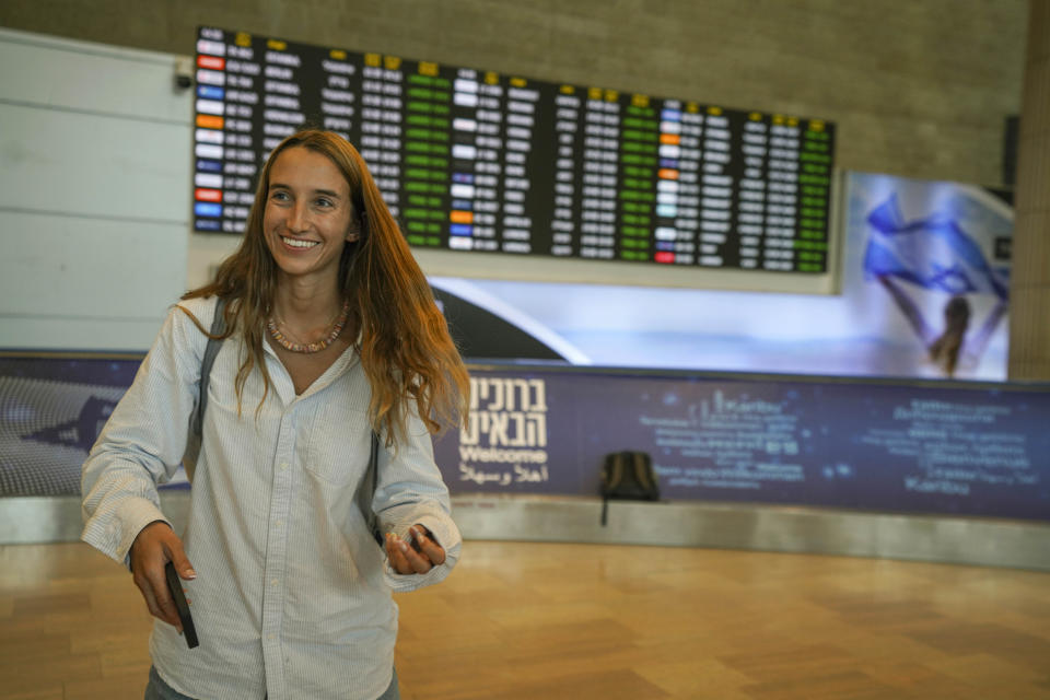 A passenger arriving from the Indian Ocean island nation of Seychelles that made an emergency stop in Saudi Arabia reacts upon landing at Ben Gurion Airport in Lod, near Tel Aviv, Israel, Tuesday, Aug. 29, 2023. Israeli media reported the Air Seychelles flight carrying 128 passengers was forced to land Monday because of an electrical malfunction. Israel's Foreign Ministry said the passengers spent the night at an airport hotel in Jeddah and were flown back by the airline on an alternate plane. (AP Photo/Tsafrir Abayov)