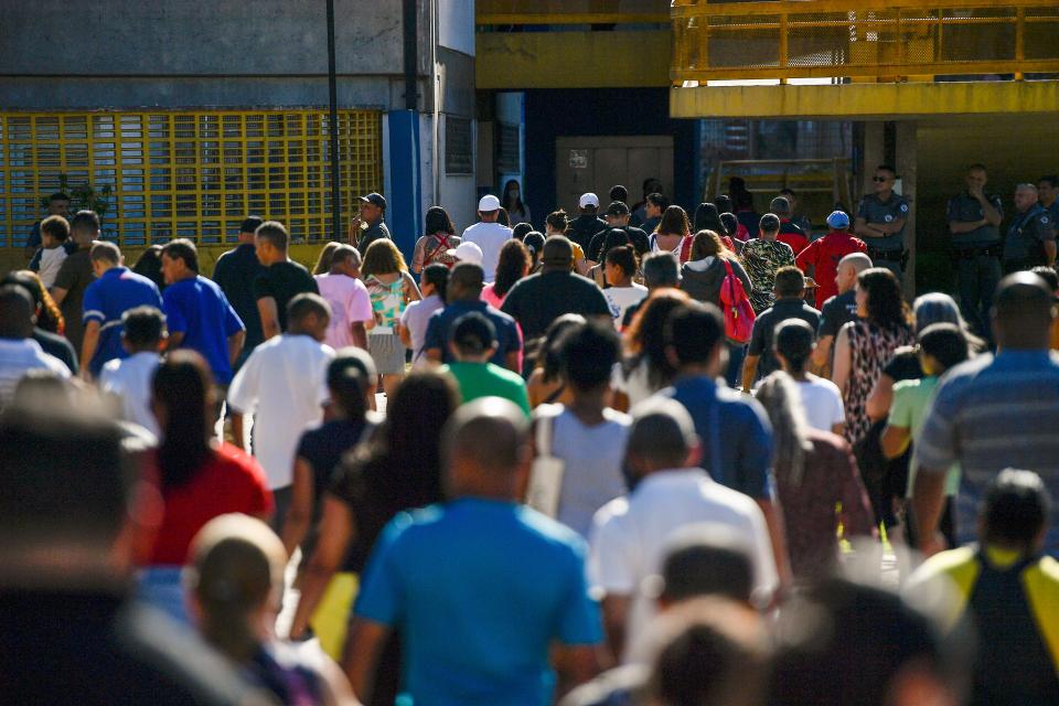 Voters arrive to a polling station during a presidential a run-off election pitting President Jair Bolsonaro against former President Luiz InÃ¡cio Lula da Silva (AP)