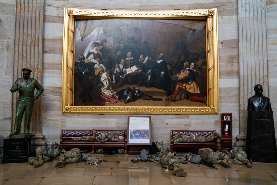 WASHINGTON, DC - JANUARY 13: Members of the National Guard sleep in the rotunda on Capitol Hill as the House of Representativs convene to impeach President Donald Trump, nearly a week after a pro-Trump insurrectionist mob breached the security of the nations capitol while Congress voted to certify the 2020 Election Results on Wednesday, Jan. 13, 2021 in Washington, DC. (Kent Nishimura / Los Angeles Times via Getty Images)