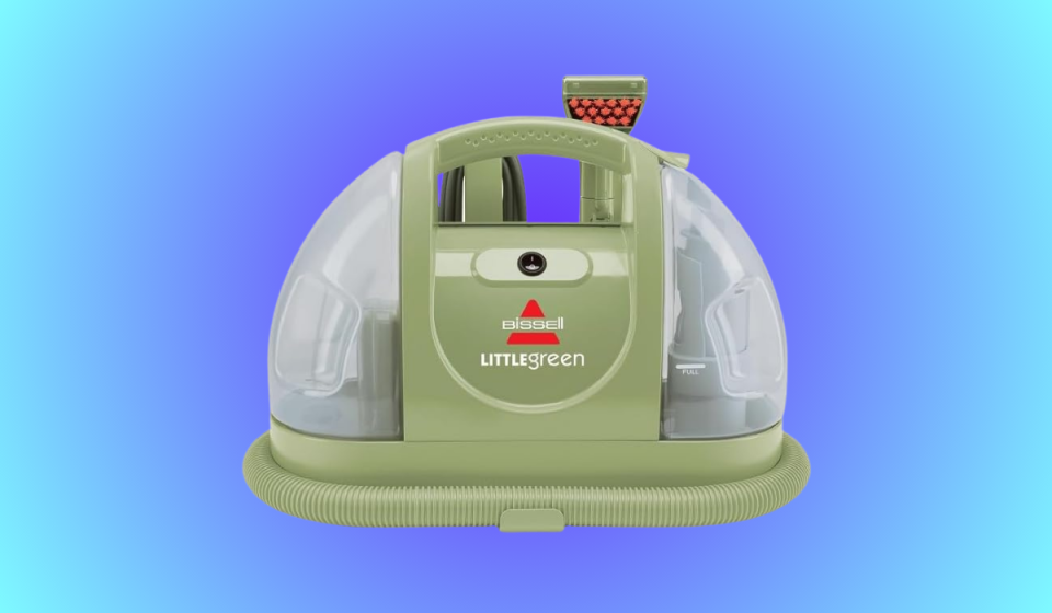 the small bissell green cleaner on a blue background