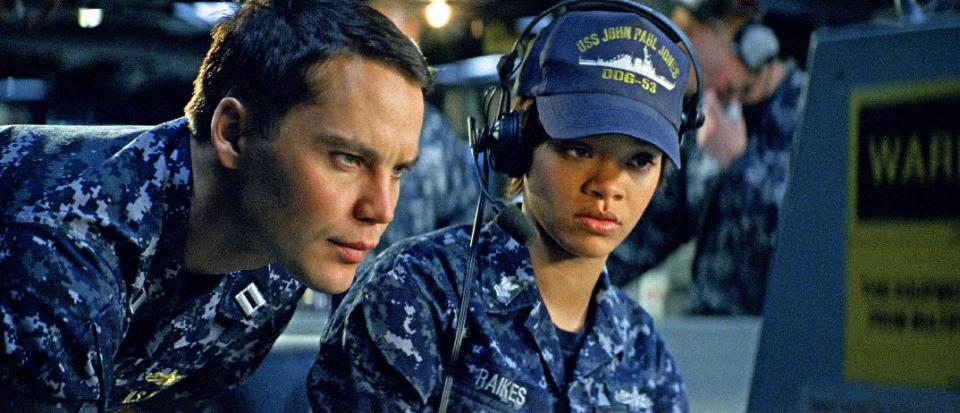 In this film publicity image released by Universal Pictures, Taylor Kitsch, left, and Rihanna are shown in a scene from "Battleship." “Battleship,” a Universal Pictures movie based on the Hasbro Inc. board game, has survived an armada of tomato-throwing critics and chugged to $170 million in ticket sales overseas. The haul goes part way to justifying the reported $209-million price tag, but after subtracting splits with theater owners, it is estimated to need about half a billion at box offices to turn a profit. With a fleet of other hotly expected blockbusters surrounding its U.S. release on May 18, the tides need to be solidly in its favor to stay above water. (AP Photo/Universal Pictures)