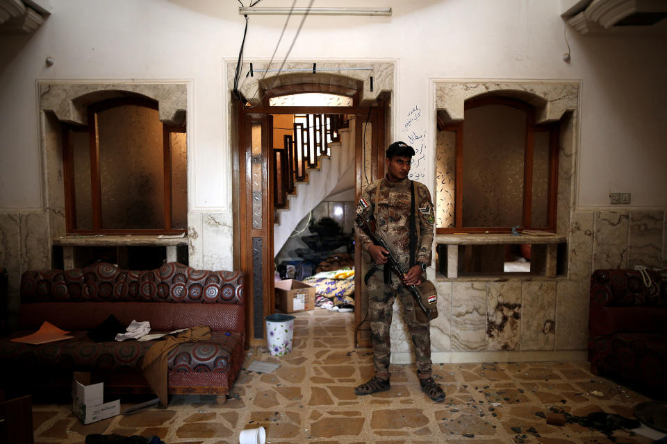 <p>A member of the Iraqi Army’s 9th Armoured Division stands inside a compound used as a prison by Islamic State militants in the 17 Tamuz (July 17) district, in western Mosul, Iraq, June 6, 2017. (Alkis Konstantinidis/Reuters) </p>