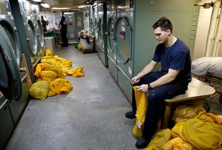 A US Navy sailor works in the laundry room of the USS Harry S. Truman aircraft carrier in the eastern Mediterranean Sea, June 14, 2016. REUTERS/Baz Ratner