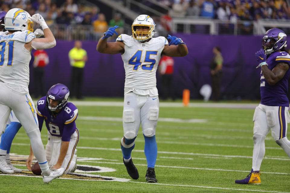 Los Angeles Chargers linebacker Tuli Tuipulotu (45) celebrates after sacking Minnesota Vikings quarterback Kirk Cousins (8) during the second half of an NFL football game, Sunday, Sept. 24, 2023, in Minneapolis. (AP Photo/Bruce Kluckhohn)