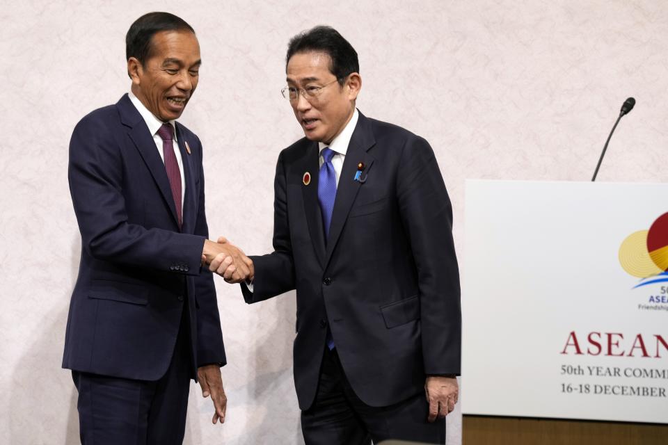 Indonesian President Joko Widodo, left, and Japan's Prime Minister Fumio Kishida shake hands after their joint chairpersons' press announcement following the meetings of ASEAN-Japan Commemorative Summit in Tokyo Sunday, Dec. 17, 2023. (AP Photo/Eugene Hoshiko, Pool)