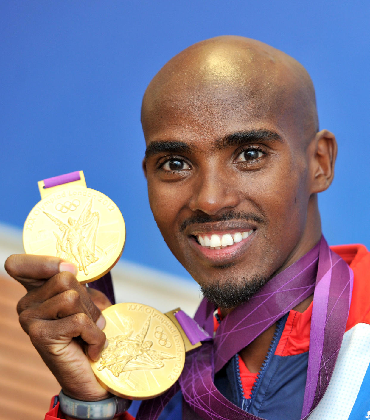 Great Britain's Mo Farah with his 2 Olympic gold medals he won in the Men's 10,000, and 5000m, pictured during a photcall at BOA House, Stratford, London   (Photo by Martin Rickett/PA Images via Getty Images)