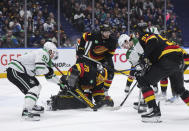 Vancouver Canucks goalie Casey DeSmith (29) stops Dallas Stars' Matt Duchene, left, and Wyatt Johnston, back right, as Canucks' Carson Soucy (7) and Tyler Myers (57) defend during the second period of an NHL hockey game Thursday, March 28, 2024, in Vancouver, British Columbia. (Darryl Dyck/The Canadian Press via AP)