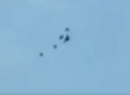 Some speculate it’s a military aircraft surrounded by four UFOs. Photo: Youtube/Of Sound Mind And Body