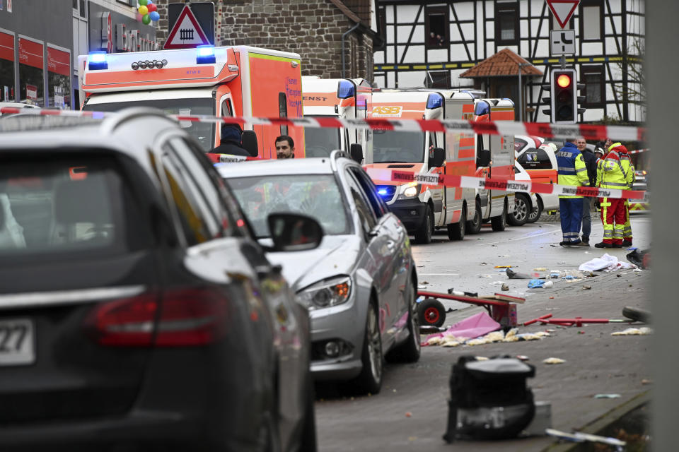 Emergency cars stand next to the scene of the accident with a car that is said to have crashed into a carnival parade in Volkmarsen, central Germany, Monday, Feb. 24, 2020. Several people have been injured, according to the police. The driver had been arrested by the police. (Uwe Zucchi/dpa via AP)