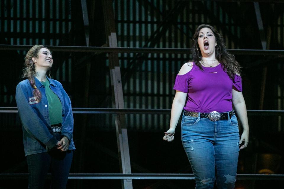 Amanda Woodbury sings onstage while Madeleine Lyon looks on with a smile in L.A. Opera's "Lucia di Lammermoor"