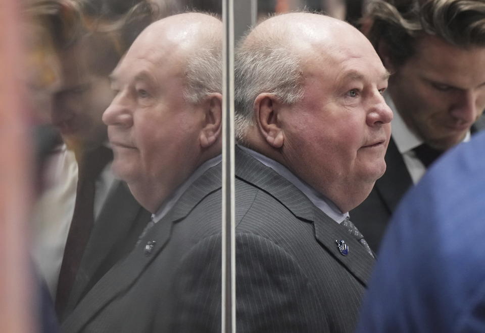 Vancouver Canucks coach Bruce Boudreau stands behind the bench before the team's NHL hockey game against the Edmonton Oilers on Saturday, Jan. 21, 2023, in Vancouver, British Columbia. (Darryl Dyck/The Canadian Press via AP)