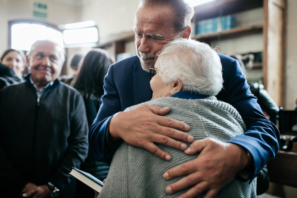 Arnold Schwarzenegger embraces Auschwitz survivor Lidia Maksymowicz at AJCF’s synagogue in Oświęcim, the town next to Auschwitz.