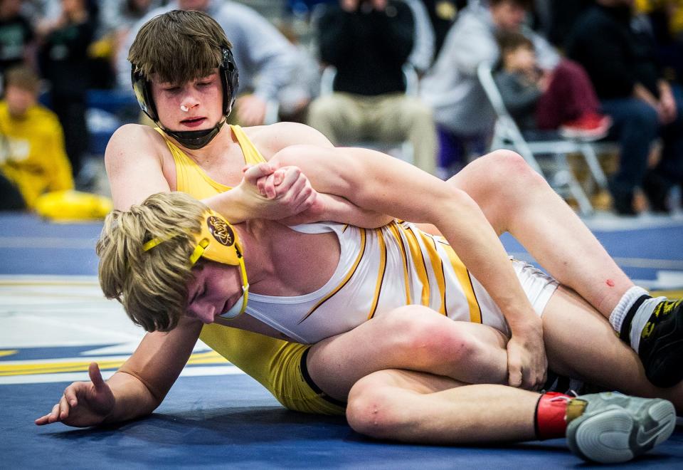 Monroe Central's Jonah Jones wrestles Cowan's Levi Abbott in the 160 pound weight class at Delta High School Saturday, Jan. 29, 2022. 