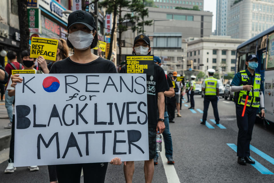SEOUL, SOUTH KOREA - 2020/06/06: A protester wearing a protective mask holds 'Koreans For Black Lives Matter' placard during the demonstration. Thousands in Seoul support U.S. protests against police brutality that caused the May 25th murder of George Floyd in Minneapolis. (Photo by Simon Shin/SOPA Images/LightRocket via Getty Images)