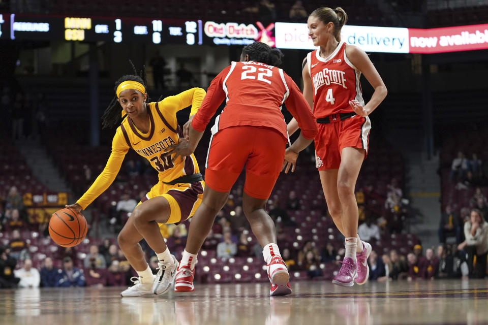 Minnesota guard Janay Sanders (30) works around Ohio State forward Eboni Walker (22) and guard Jacy Sheldon (4) during the first half of an NCAA college basketball game Thursday, Feb. 8, 2024, in Minneapolis. (AP Photo/Abbie Parr)