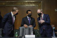 FireEye CEO Kevin Mandia, SolarWinds CEO Sudhakar Ramakrishna and Microsoft President Brad Smith talk before a Senate Intelligence Committee hearing on Capitol Hill on Tuesday, Feb. 23, 2021 in Washington. (Drew Angerer/Photo via AP)