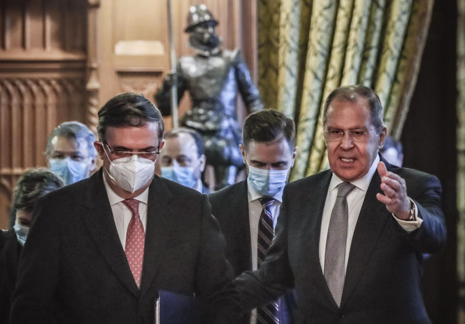 Russian Foreign Minister Sergei Lavrov, right, and Mexican Foreign Minister Marcelo Ebrard enter a hall during their meeting in Moscow, Russia, Wednesday, April 28, 2021. Mexican Foreign Minister Marcelo Ebrard is on a working visit to Moscow. (Yuri Kochetkov/Pool Photo via AP)