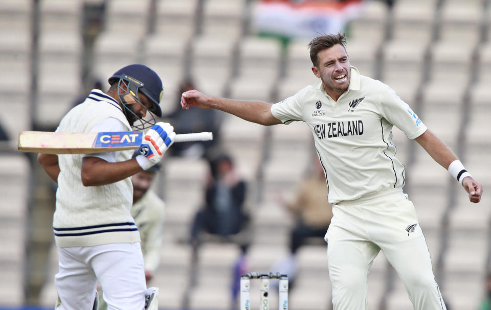 New Zealand's Tim Southee, right, celebrates the dismissal of India's Rohit Sharma, left, during the fifth day of the World Test Championship final cricket match between New Zealand and India, at the Rose Bowl in Southampton, England, Tuesday, June 22, 2021. (AP Photo/Ian Walton)
