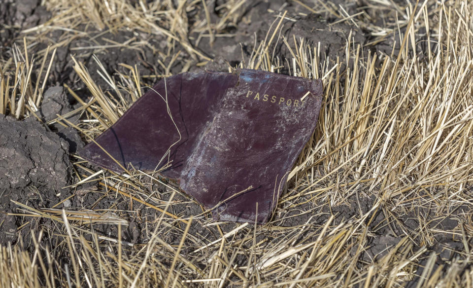 A passenger passport lies on the ground at the scene of an Ethiopian Airlines flight crash near Bishoftu, or Debre Zeit, south of Addis Ababa, Ethiopia, March 11, 2019. (Photo: Mulugeta Ayene/AP)