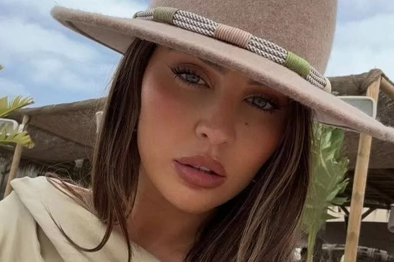 Emma Milton wearing a hat