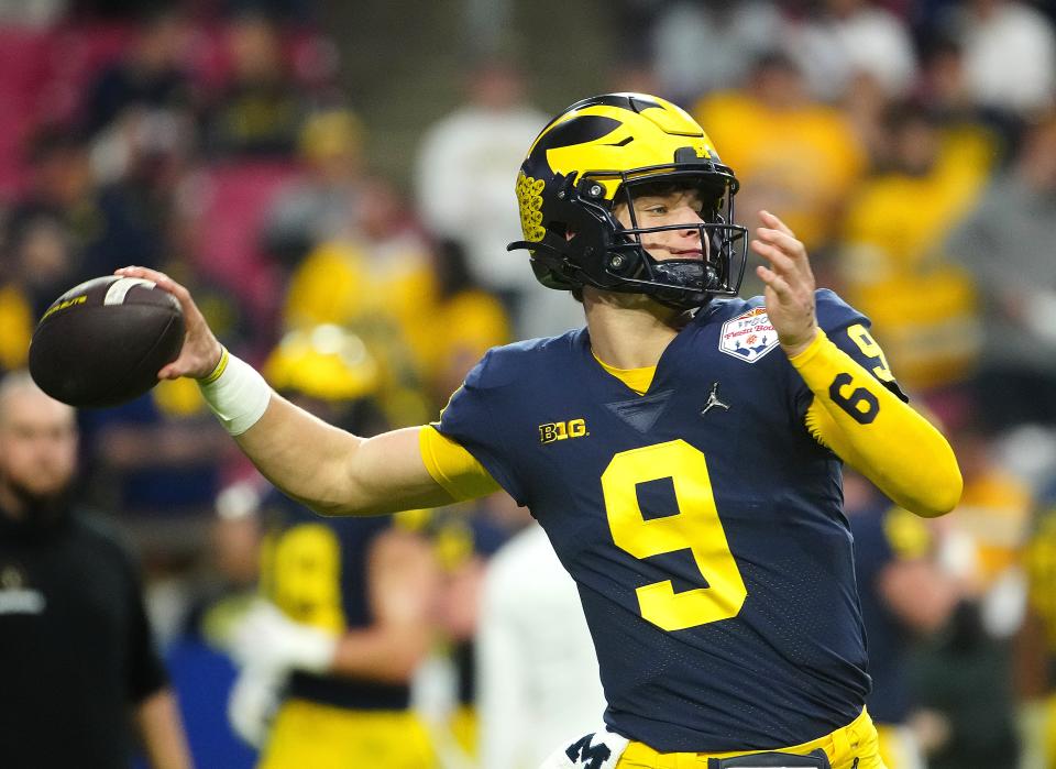 December 31, 2022; Glendale, Ariz; USA; Michigan quarterback JJ McCarthy (9) throws a pass during the pregame before the Fiesta Bowl at State Farm Stadium.