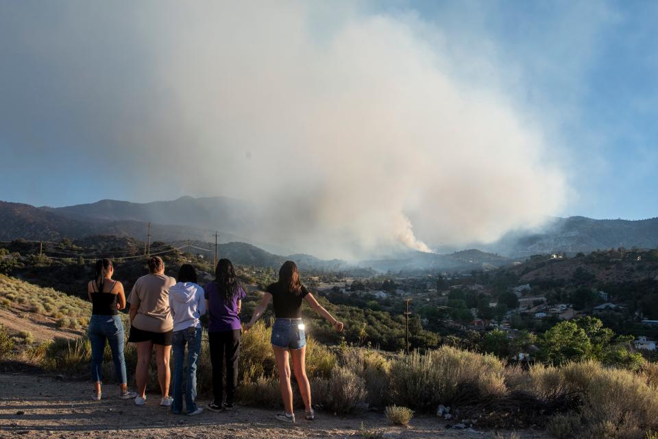 The Vivirto family of Lake Los Angeles watches the Sheep fire burn in Wrightwood, California, on June 12, 2022. Misty Vivirto, second from left, is a volunteer for the Los Angles County Animal Control, the family made four runs to evacuate animals between Saturday night and Sunday.