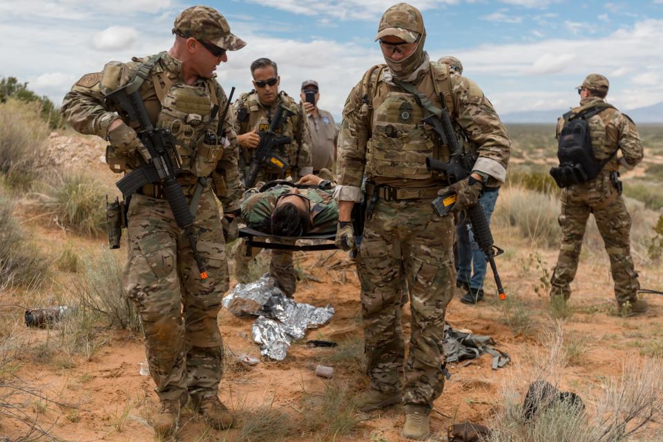 U.S. Border Patrol Search Trauma and Rescue (BORSTAR) candidates carry a hurt migrant on a stretcher during their last field rescue training course on Thursday, Aug. 18, 2022, at McGregor Training Area, Range 11 in Ft. Bliss, before graduating the following day.