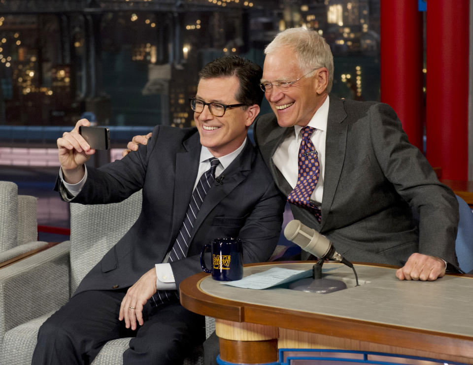 In this photo provided by CBS, Comedy Central’s Stephen Colbert, left, takes a “selfie” with host David Letterman on the set of the “Late Show with David Letterman,” Tuesday, April 22, 2014 in New York. This was Colbert’s first visit to the show since CBS announced that he will succeed Letterman as host when he retires in 2015. (AP Photo/Jeffrey R. Staab) MANDATORY CREDIT, NO SALES, NO ARCHIVE, FOR NORTH AMERICAN USE ONLY