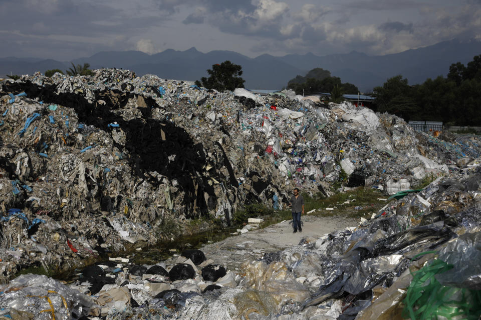 A man walks through an illegal dumpsite teeming with plastic trash imported from the United States, in Ipoh, Malaysia, Jan. 30, 2019.  (Photo: Joshua Paul for HuffPost)