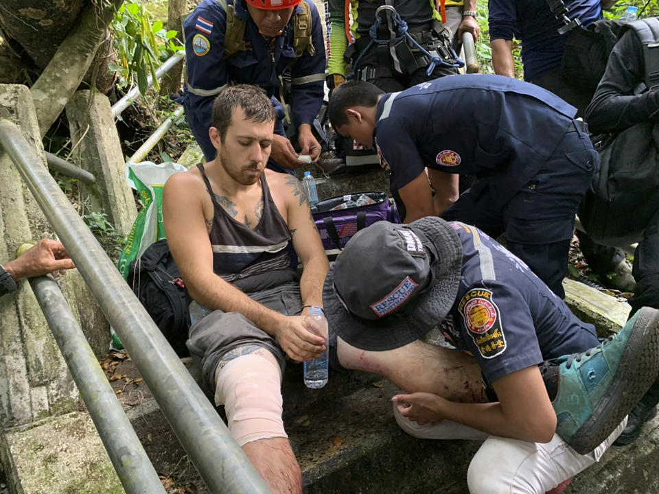 In this image released by the Phattalung Rescue Organization, a base jumper is treated after being rescued from the edge of a cliff, Monday, Jan. 13, 2020, in Phattalung, Thailand. An Austrian base jumper, Johannes Grasser, 28, was rescued in the southern Thai province after being stuck on a near vertical cliff for hours when his parachute caught a rock’s edge, almost 200 meters (656 feet) above the around. (Phattalung Rescue Organization via AP)