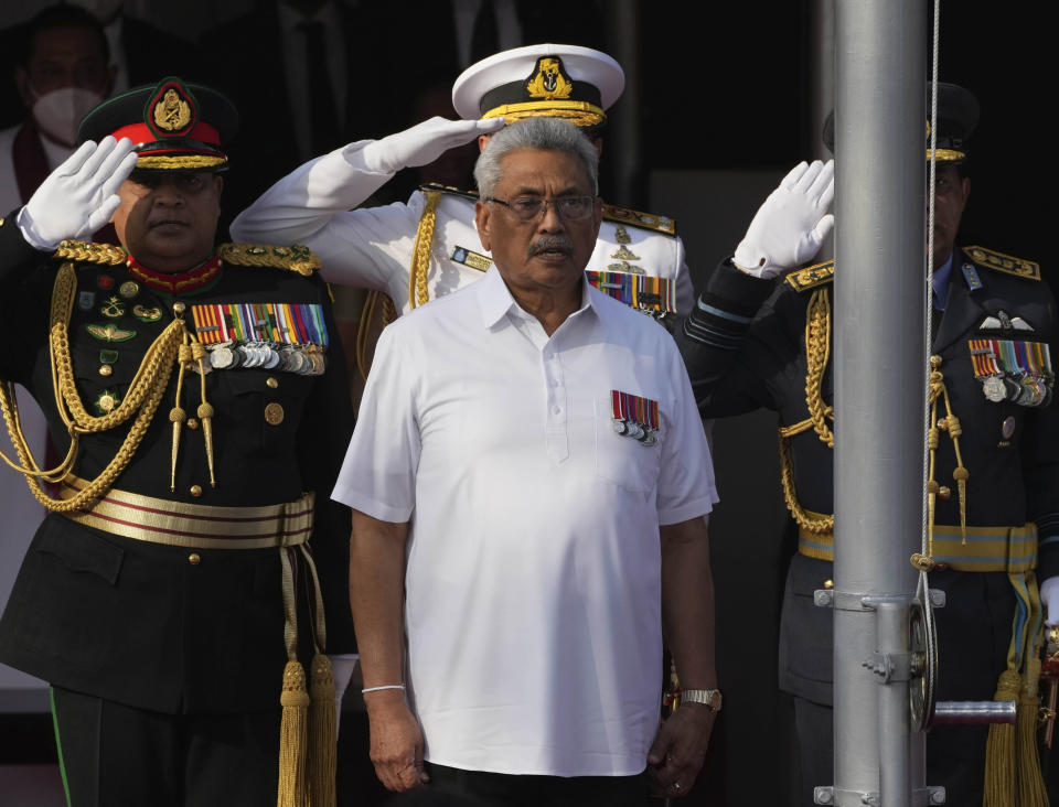 FILE- Sri Lankan president Gotabaya Rajapaksa sings the national anthem of Sri Lanka during the country's Independence Day celebration in Colombo, Sri Lanka, Feb. 4, 2022. Sri Lanka’s economic collapse has been blamed on its president and his family, and demonstrators have for months demanded his resignation, the last of six family members still clinging to power. On Sunday, President Gotabaya Rajapaksa was nowhere to be found, his official residence occupied by thousands of angry citizens who were no longer taking no for an answer, now squatting in his bedroom and swimming in his pool. (AP Photo/Eranga Jayawardena, file)