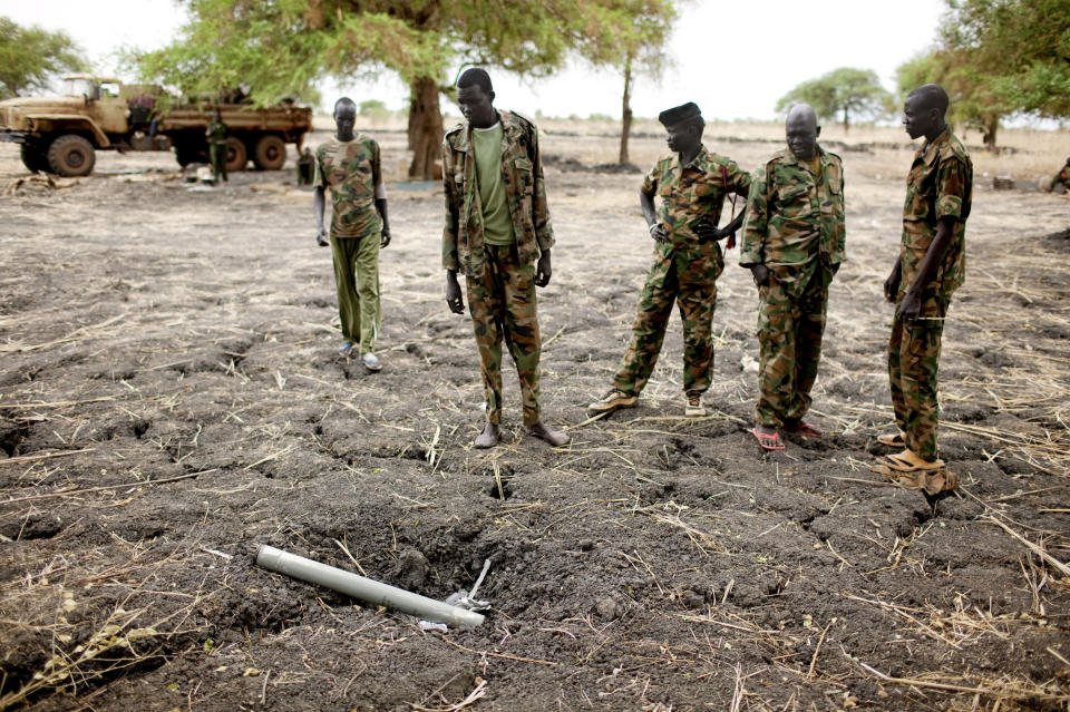 Sudan People's Liberation Army (SPLA) soldiers inspect ordinance dropped by the Sudan Armed Forces (SAF) at a frontline position in Pana Kuach, Unity State, South Sudan. SAF forces regularly employ air strikes, a capability that southern forces lack. In late April, tensions between Sudan and South Sudan erupted into armed conflict along their poorly defined border. Thousands of SPLA forces have been deployed to Unity State where the two armies are at a tense stalemate around the state's expansive oil fields. Fighting between the armies lulled in early May after the U.N. Security Council ordered the countries to resume negotiations. South Sudan seceded from the Republic of Sudan in July 2011 following decades of civil war. (AP Photo/Pete Muller)