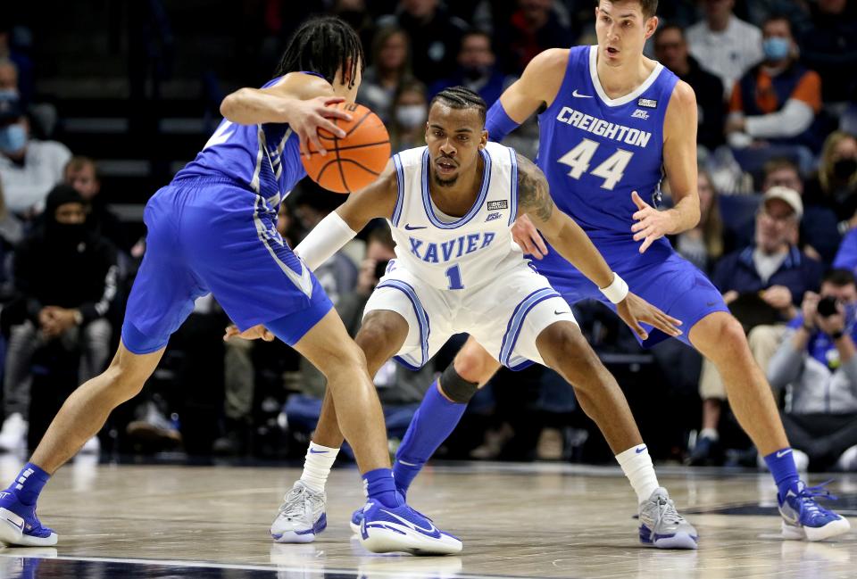 Xavier Musketeers guard Paul Scruggs (1) keeps watch of Creighton Bluejays guard Ryan Nembhard (2) during the first half Saturday January 15, 2022 at the Cintas Center. 